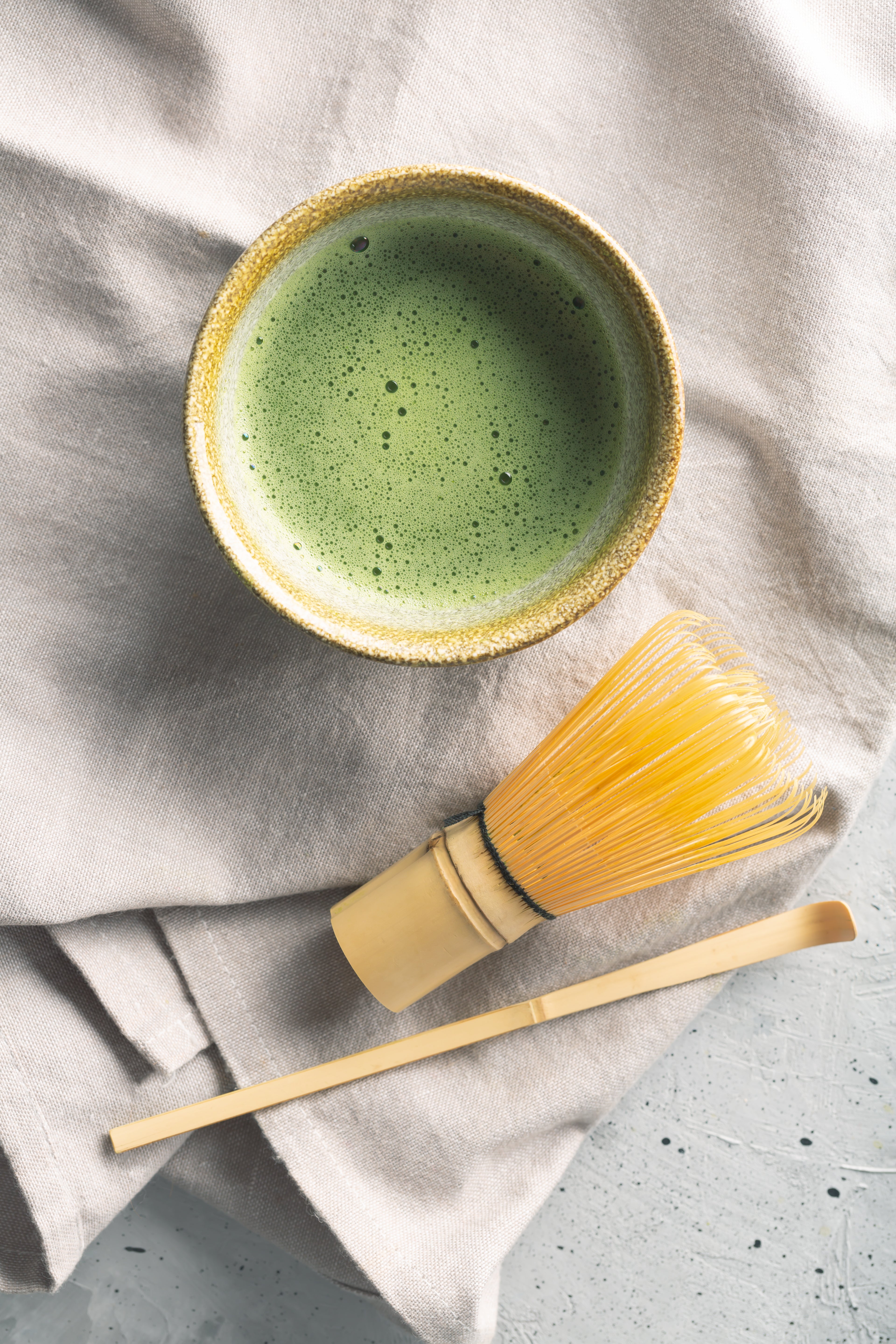 top-view-green-tea-matcha-bowl-concrete-surface.jpg